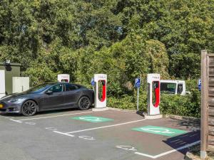 a car parked in a parking lot with two gas pumps at ibis budget Senlis in Senlis