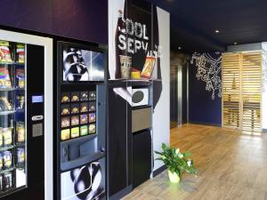 a large refrigerator in a room with drinks in it at ibis budget Cherbourg - La Glacerie in Cherbourg en Cotentin