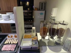 a counter with some food and containers of food at ibis budget Romorantin in Romorantin