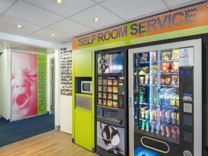 a soft drink vending machine in a store at Ibis Budget Fréjus Capitou in Fréjus +56 photos
