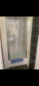 a shower in a bathroom with a glass door at Forum - pensjonat przy plaży in Dźwirzyno +62 photos