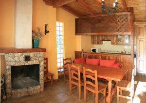 a dining room with a table and a fireplace at Casas Rurales Ribera de Salobre in Salobre