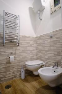 a bathroom with a toilet and a sink in it at Il Brigantino in Cori +5 photos
