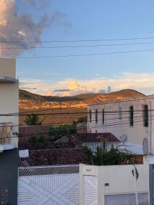 a view of a white building with a fence at Quarto Oliveira in Ibicoara