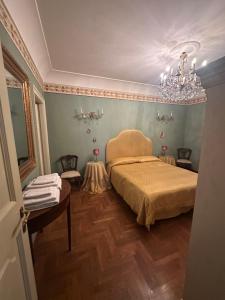 a bedroom with a bed and a chandelier at B&B La Porticella in Viterbo