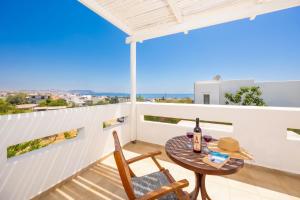 a patio with a table and chairs on a balcony at Villa Loka in Gennadi