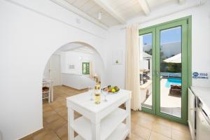a living room with a table and a view of a pool at Villa Loka in Gennadi