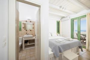 a bedroom with a bed and a sink and a bathroom at Villa Loka in Gennadi +21 photos