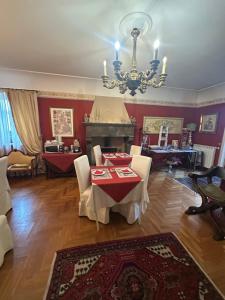 a living room with a table and chairs and a chandelier at B&B La Porticella in Viterbo