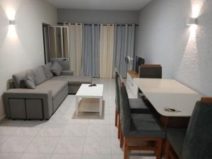 a living room with a couch and a table at Salão Zuzu in Ribeira Grande