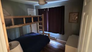 a bedroom with a bunk bed and a window at Lies by AvantStay in North Creek