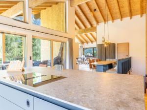 an open kitchen and dining room with a large counter top at Dachstein Grand Alpine Lodge in Mitterberg-Schladming-Dachstein