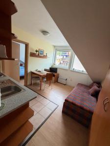 a kitchen and living room with a bed and a table at Donovaly apartmán 33 in Donovaly +8 photos