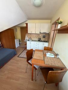 a kitchen and dining room with a table and chairs at Donovaly apartmán 33 in Donovaly