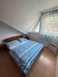 a bedroom with a bed and a large window at Donovaly apartmán 33 in Donovaly