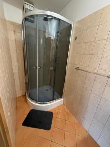 a shower with a glass door in a bathroom at Donovaly apartmán 33 in Donovaly