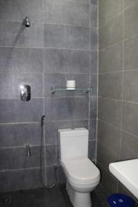 y baño con aseo blanco y ducha. en Lohas Beach Resort Villa en Kalutara
