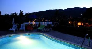 a swimming pool with chairs and a view of the water at Chalé da Fonte - T2 in Geres