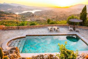 a swimming pool with a view of the mountains at El Valle Dorado in El Gastor