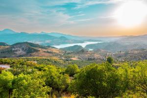 a view of a valley with a lake and mountains at El Valle Dorado in El Gastor +64 photos