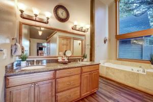 a bathroom with two sinks and a large mirror at On Tahoe Time - Pets Pool Table Game Room in South Lake Tahoe +32 photos