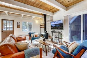 a living room with leather furniture and a fireplace at Panorama Chalet in Nebelhorn