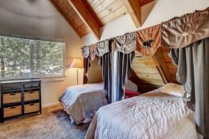 a bedroom with two beds and a window at Panorama Chalet in Nebelhorn