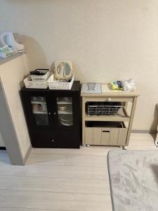 a room with a desk with a phone on it at 短期賃貸ビッグバーンズマンション田上 in Kagoshima