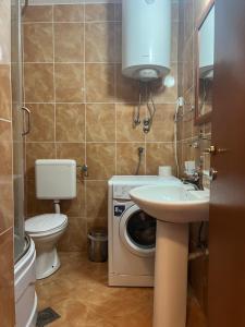 a bathroom with a washing machine and a sink at Vila Natalia in Petrovac na Moru +112 photos