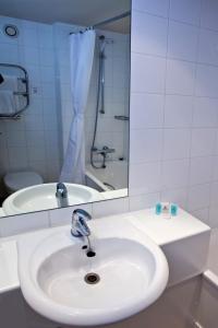 a bathroom with a sink, toilet and bathtub at Britannia Hotel Bolton in Bolton