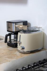 a toaster sitting on top of a kitchen counter at Kassuky Home in Cabarete