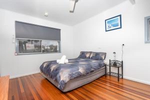a bed in a white room with a window at Koala Lodge Studio 1 in Iluka
