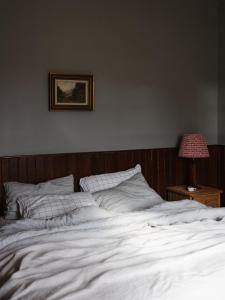 a bedroom with a white bed with a picture on the wall at 101 Oatlands Tasmania in Oatlands