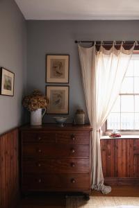 a bedroom with a dresser and a window at 101 Oatlands Tasmania in Oatlands