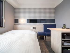 a hotel room with a bed and a desk at Super Hotel Anan City Hall Smoke-Free in Anan