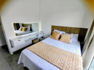 a bedroom with a bed and a large mirror at Sobrado Matinhos 480 m da praia l novo l central 3quartos in Matinhos