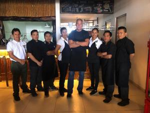 a group of men in suits posing for a picture at Bamboo Lodge Paracas in Paracas