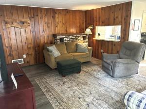 a living room with a couch and a chair at Hidden Haven Cottages in Lake City