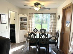 a dining room with a table with chairs and a ceiling fan at Hidden Haven Cottages in Lake City +17 photos