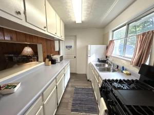 a kitchen with a sink and a stove top oven at Hidden Haven Cottages in Lake City