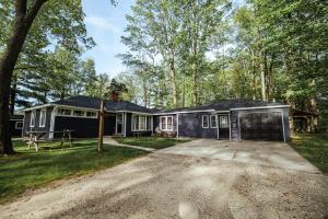 a house with a garage in the woods at Hidden Haven Cottages in Lake City