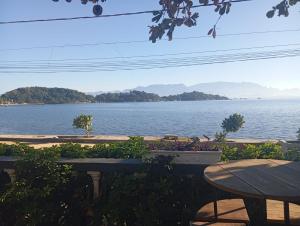 a view of a large body of water with two tables at A Tóca in Rio de Janeiro