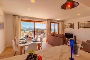 a living room with a table and a couch at Seafront Marina 1 Apartment in Pollença