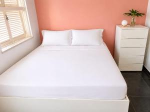 a white bed in a room with a window at A Tóca in Rio de Janeiro