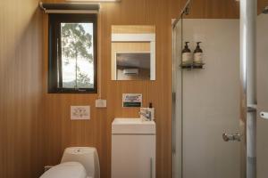 a small bathroom with a toilet and a window at Three-Kalm & Four-Sol by Tiny Away in Rainbow Flat