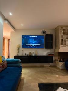 a living room with a large flat screen tv on the wall at Best Sea View in Morocco in Sidi Bouqnadel