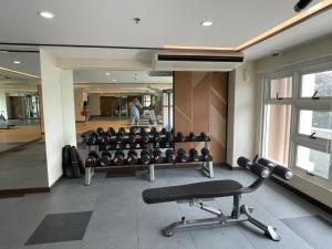 a gym with a lot of equipment in a building at Infina Towers in Manila
