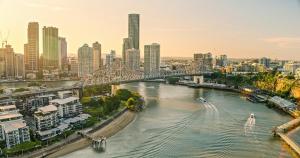 a bridge over a river in a city with buildings at InterContinental Brisbane by IHG in Brisbane