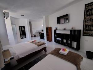 a large bedroom with two beds and a fireplace at Darwin-Galápagos Apartment in Puerto Ayora