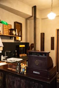 a kitchen with a stove on top of a counter at sishi hostel 巳時旅宿 in Tainan
